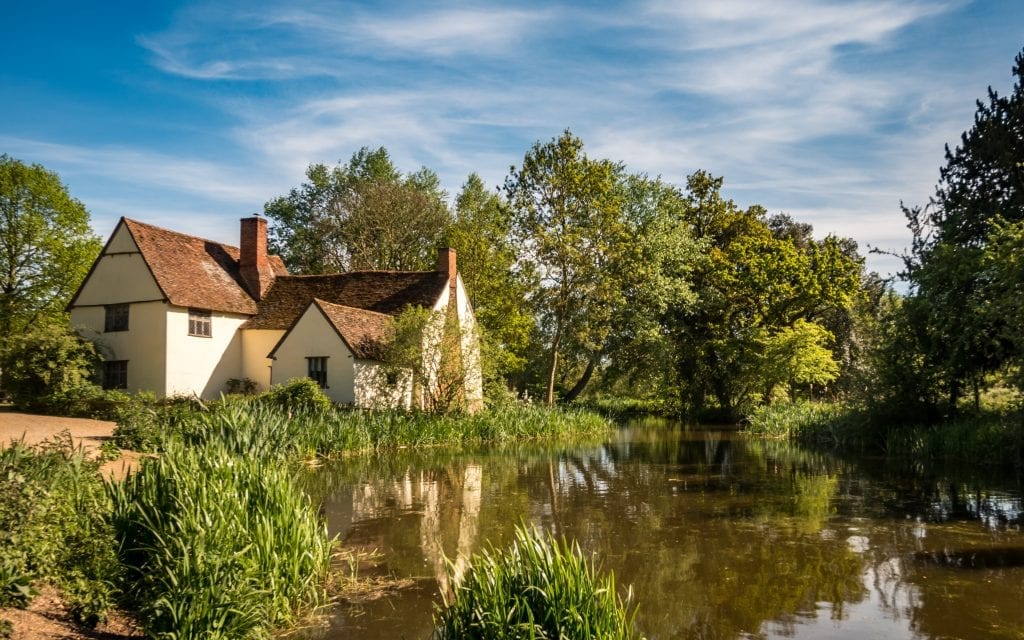 A contemporary view of Flatford Mill, the scene painted by John Constable in his painting 'The Hay Wain' in the Dedham Vale district of East England on a bright summers day.
