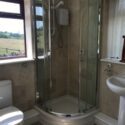 The shower room has toilet, sink, shower and heated towel rail.